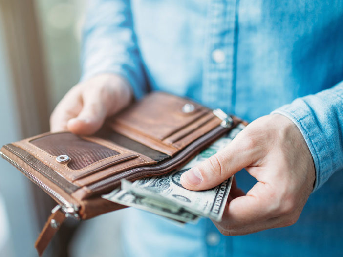 Man taking money out of wallet.